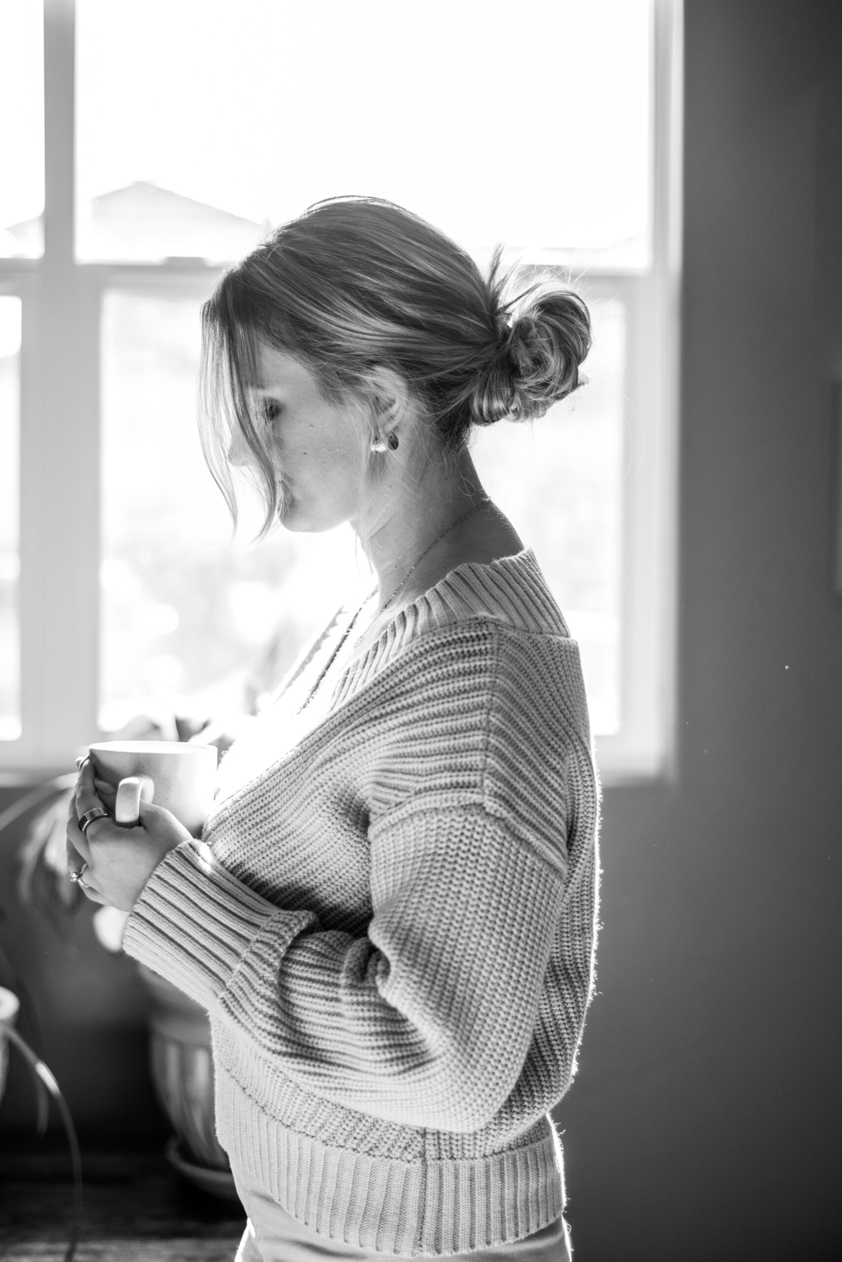 Peaceful woman enjoying therapeutic tea ritual by window, demonstrating mindful self-care practices for emotional wellbeing